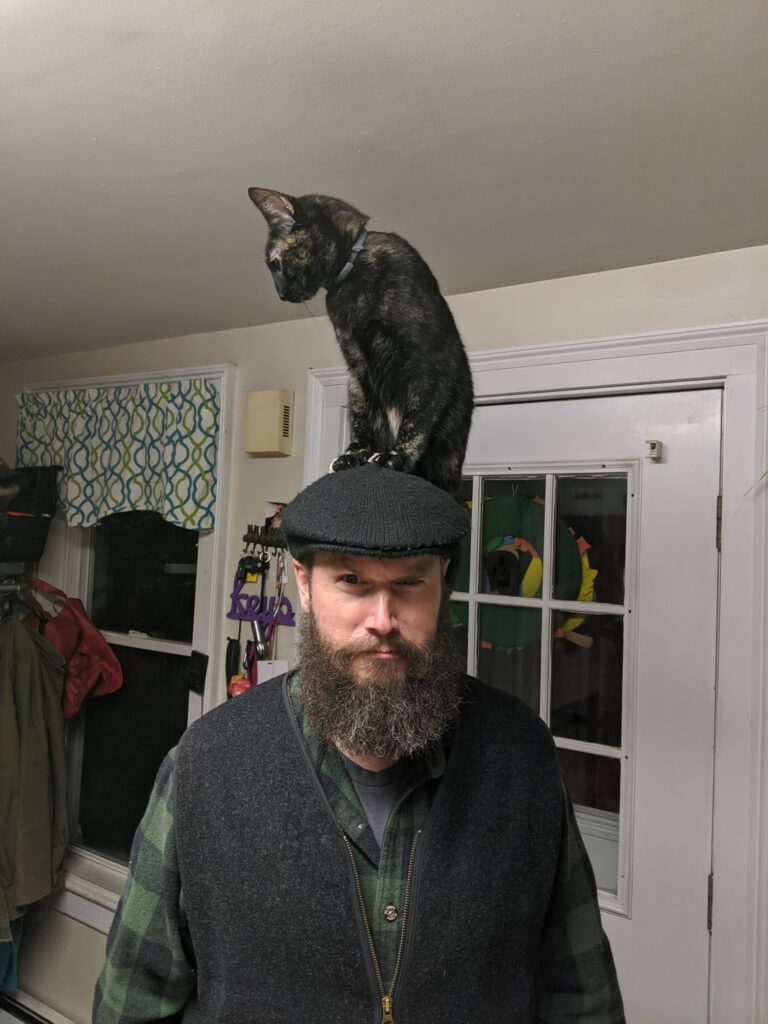 Malcolm Fowler with a cat on his head